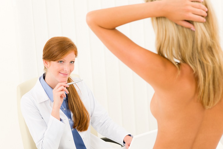 Plastic surgery female doctor look patient breast