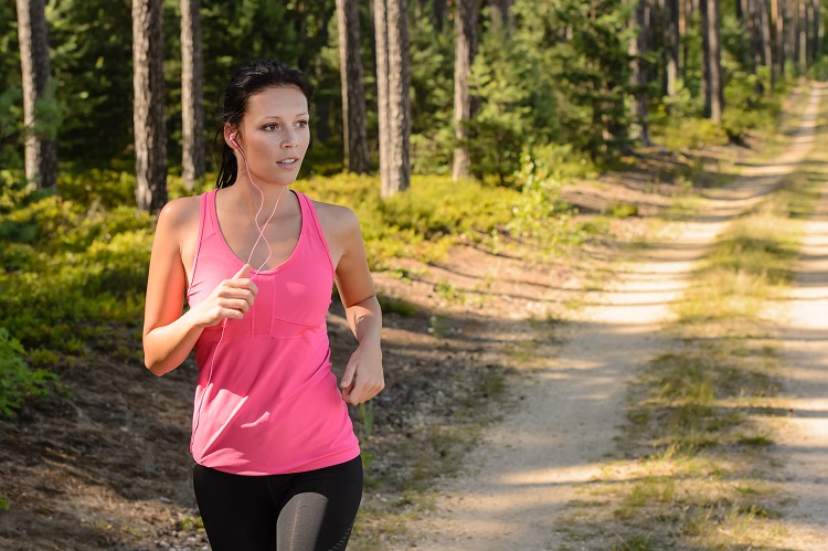 Woman running through forest outdoor training
